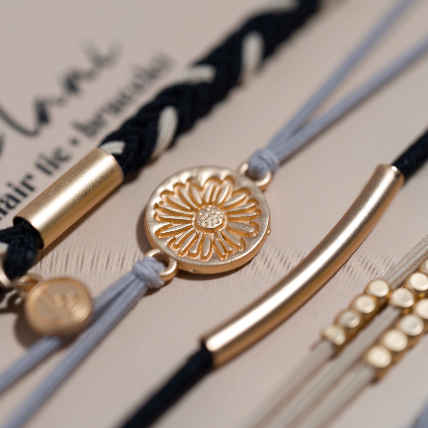K'lani hair tie bracelets - "Inspire" Grey & Black with Gold Flower Accent Hair Tie Bracelets